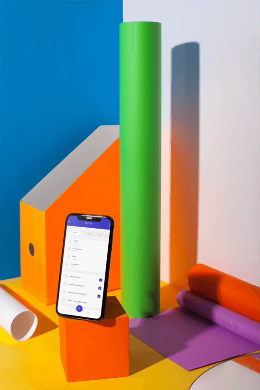 Portrait Of An Iphone X Mockup Standing On A Colorful Desk