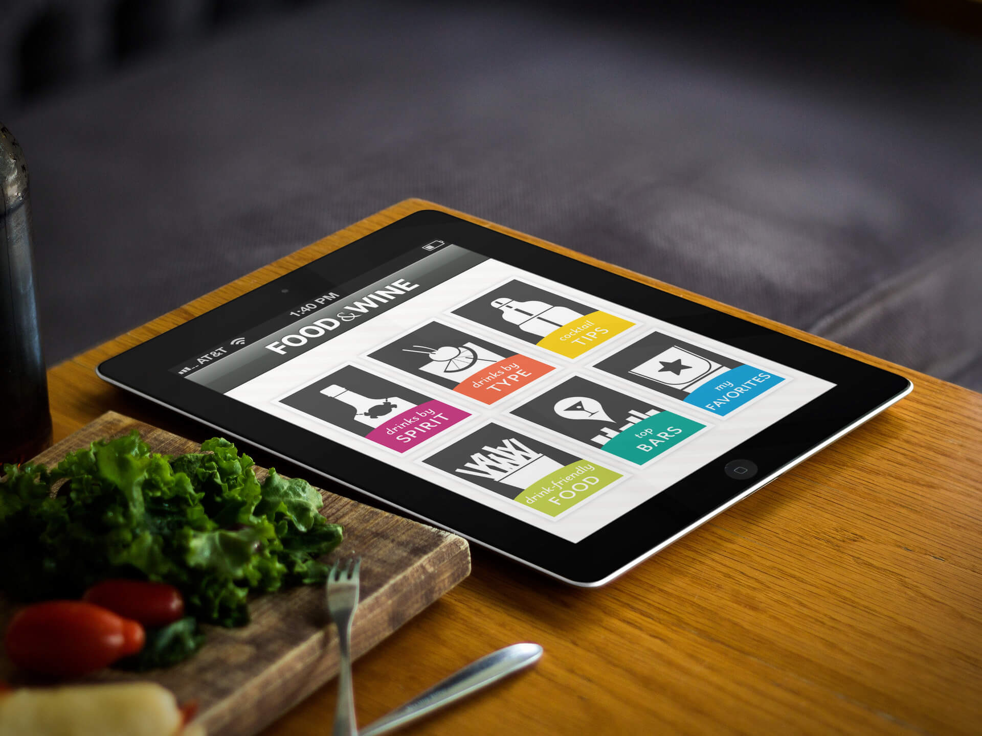 Black iPad Mockup in a Wooden Tabletop Next to a Cutting Board and Vegetables