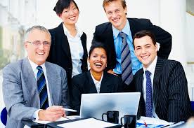 Stock Image of a Group of Business Executives Gathered Around a Computer and Laughing