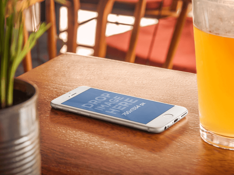 iPhone 6 Mockup on Wooden Table next to a Beer