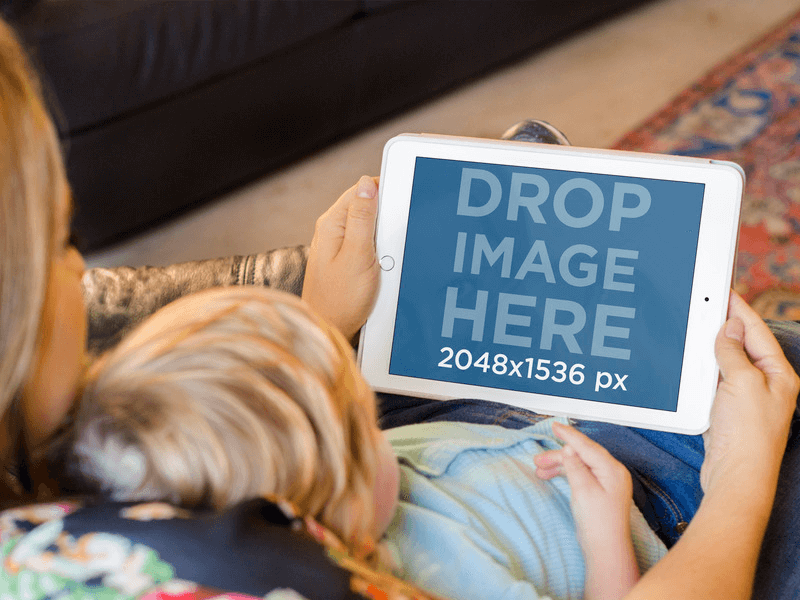 iPad Mockup of Mom and Baby Using White iPad in Sofa