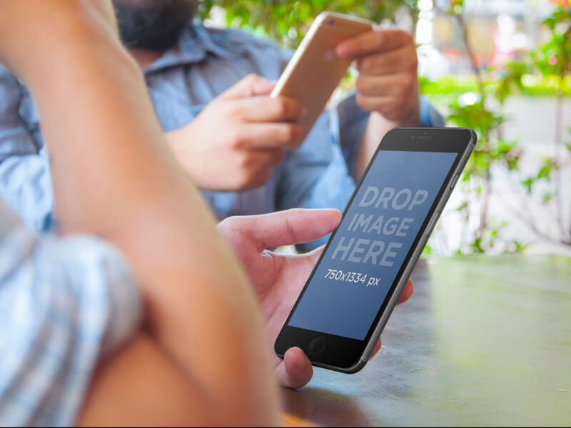 Friends Relaxing Holding an iPhone 6 Mockup