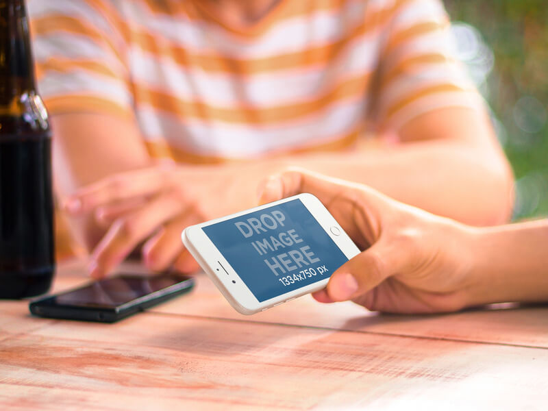 iPhone 6 Mockups held by a Man Hanging Out