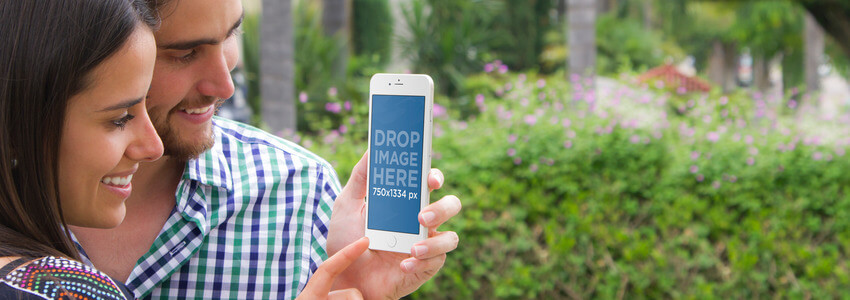 iPhone 6 Mockup of a Young Couple at the Park