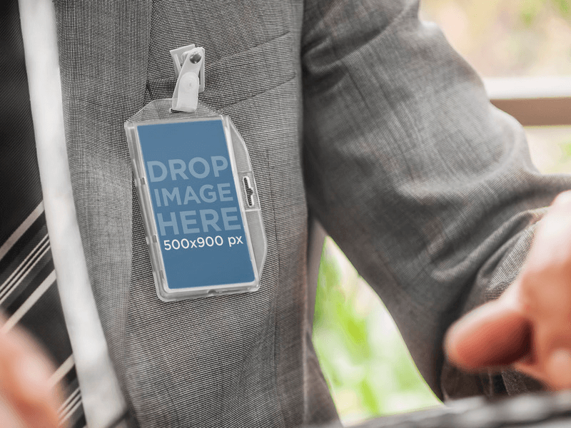 MOCKUP OF MAN CARRYING A BADGE HOLDER AT THE OFFICE