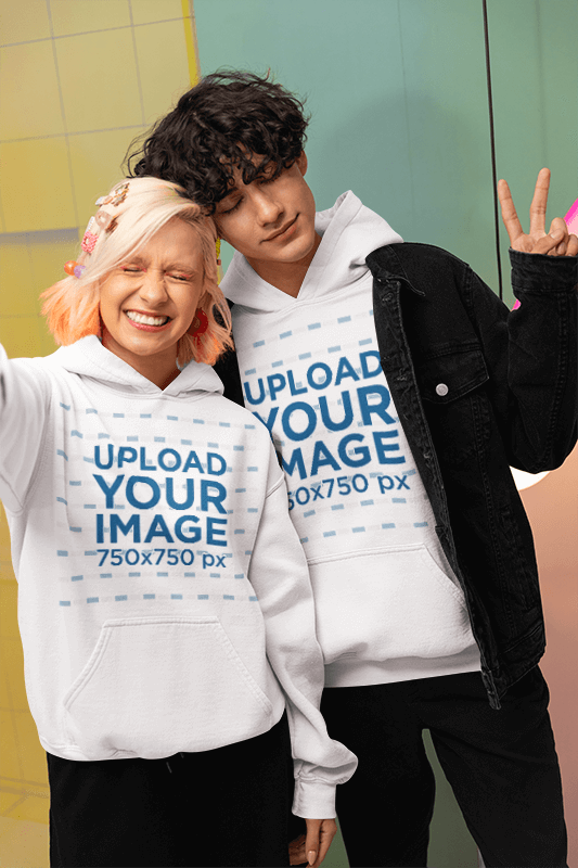 New Pop Wave Style Mockup Of Two Friends Taking A Selfie In Matching Hoodies