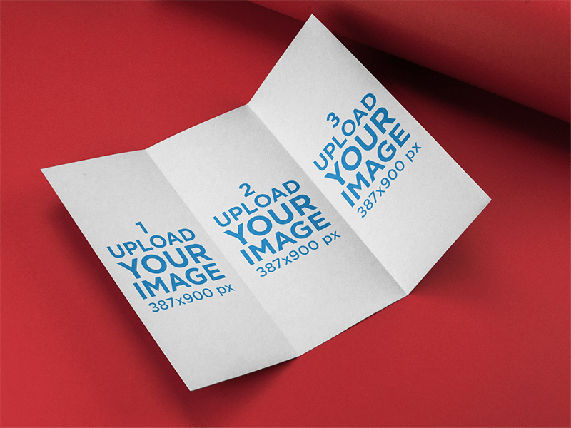 Open Trifold Brochure Mockup Lying On A Red Surface