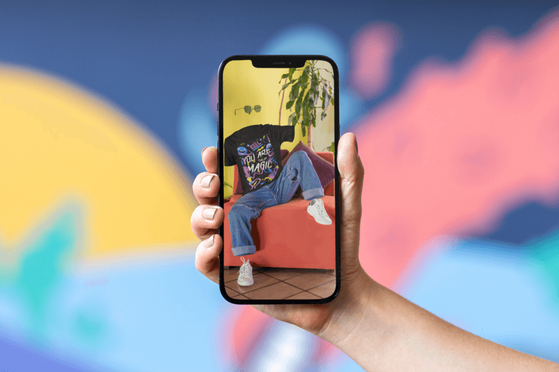 Mockup Of A Hand Holding An Iphone In Front Of A Colorful Wall