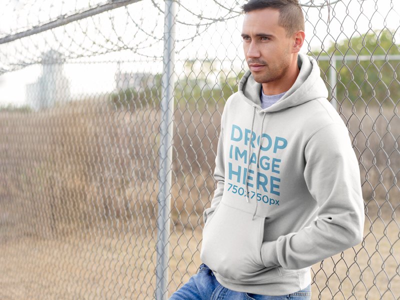 Man Leaning on a Wire Fence Hoodie Mockup