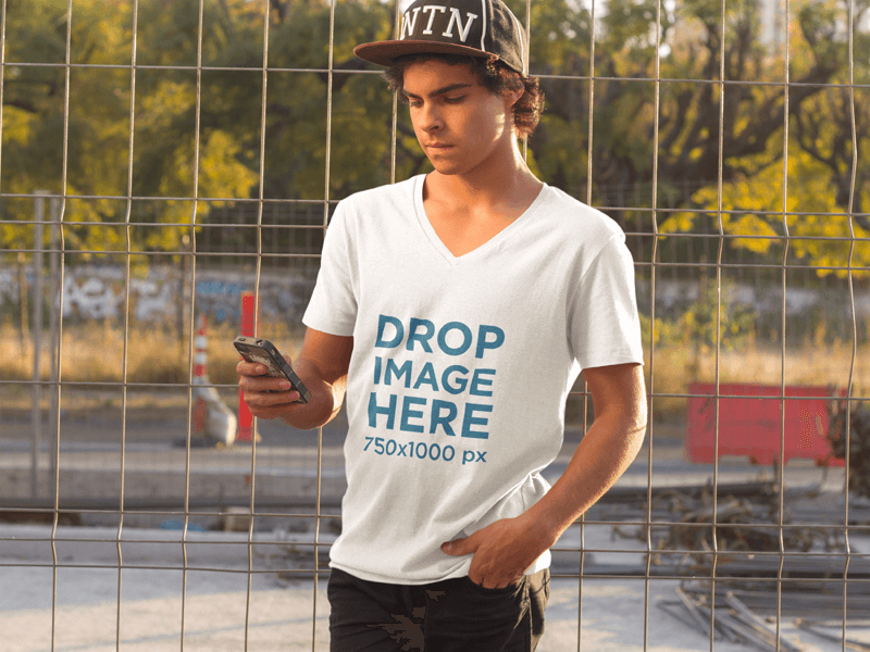 Guy at a Skate Park Using an iPhone T-Shirt Mockup