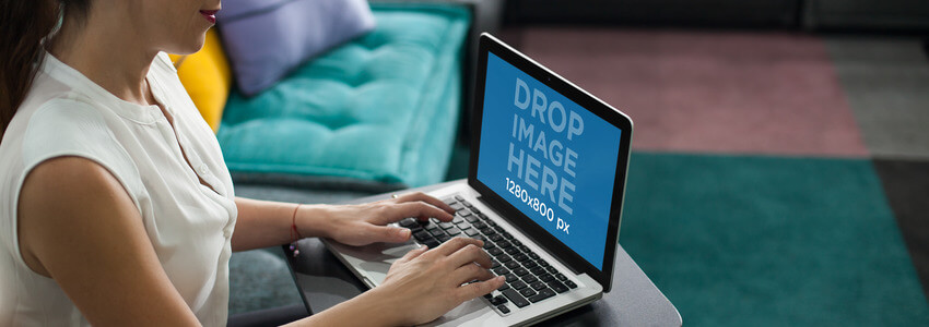 Laptop Mockup of a Young Woman Using a MacBook Pro at Home