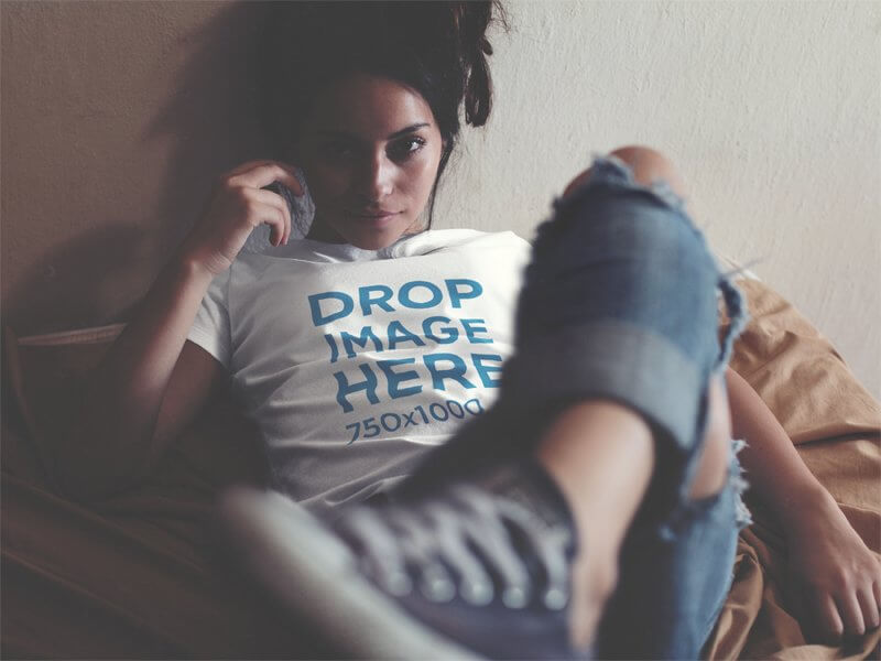 T-Shirt Mockup of an Alternative Young Woman Lying in Bed