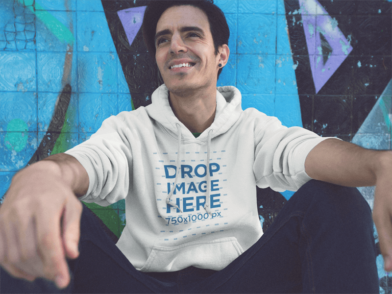 Pullover Hoodie Mockup of a Young Man Sitting and Having Fun at a Skate Park