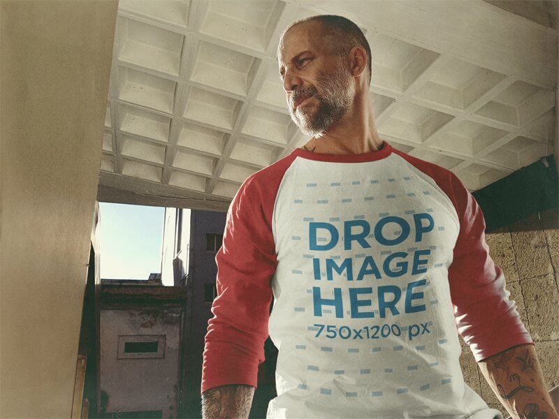 Raglan T-Shirt Mockup of a White Middle-Aged Man Standing Inside a City Building