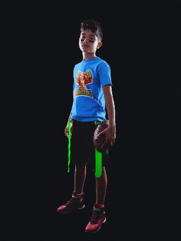 Mockup of a kid holding a football ball while his football jersey presents different sportive alternatives 