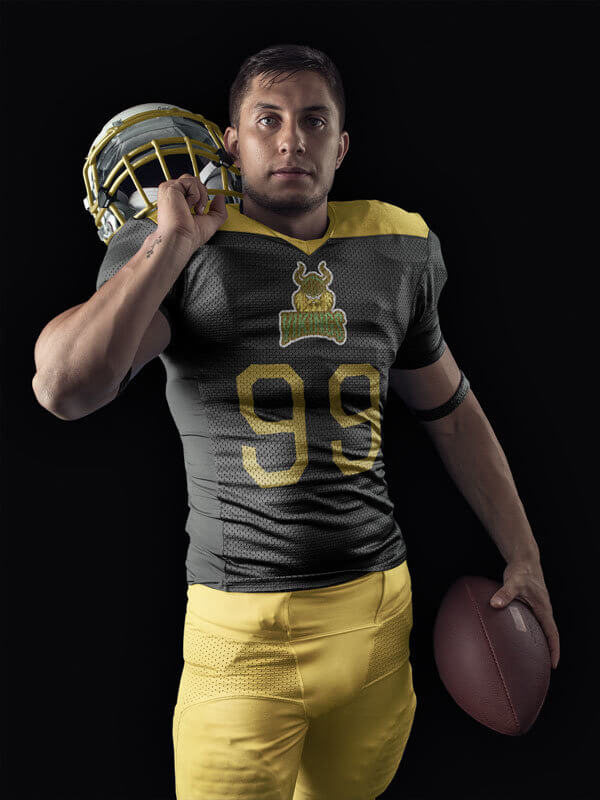 a middle age man posing with a football customized uniform 