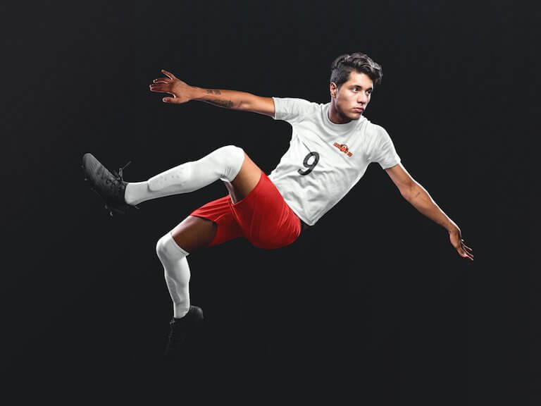 Custom soccer jersey logo mockup of a man doing a scissor kick