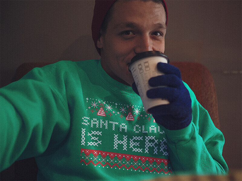 Boy wearing a Ugly Christmas Sweater and Zipping His Coffe