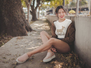 Smiling Asian Woman Wearing A Crop Top Tee Mockup At A Park