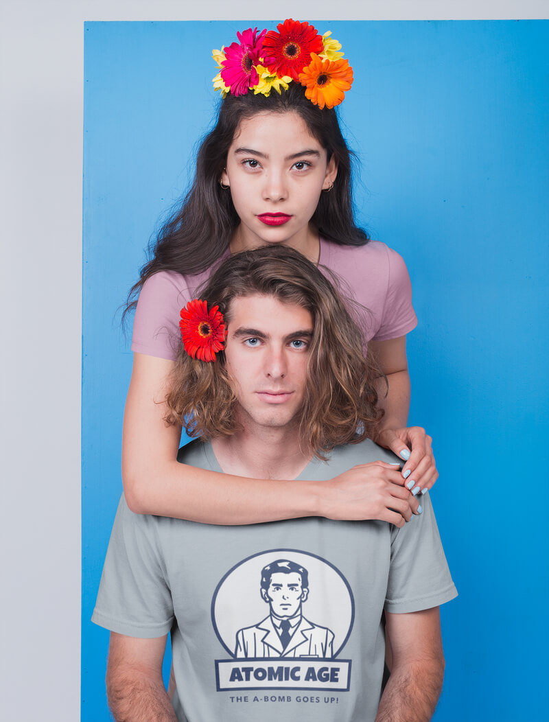 Blonde Guy Wearing A T Shirt Mockup Being Hugged By An Asian Girl With Flowers On Their Heads
