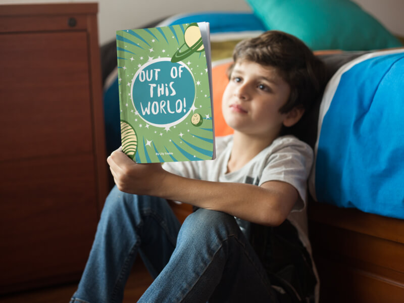 Little Kid Reading A Book Mockup By His Bed