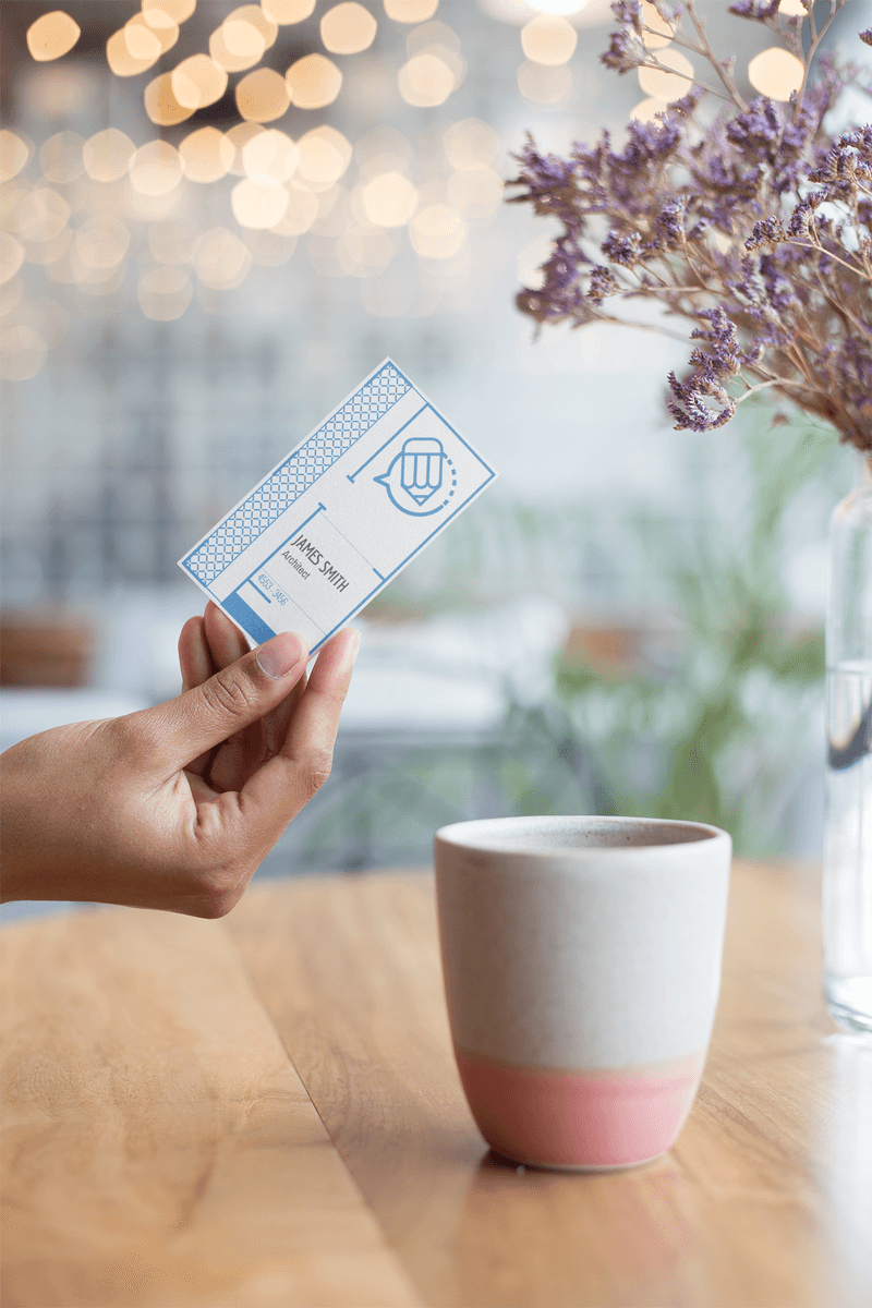 Vertical Business Card Held On A Coffee Table