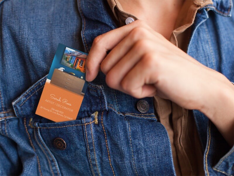 Woman Placing A Business Card In Her Jacket