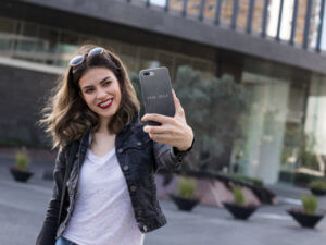 Iphone Case Mockup Held By A Smiling Woman