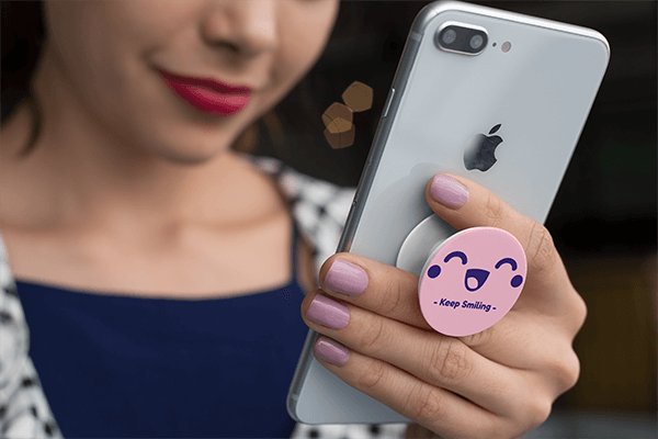 A Girl holding an iPhone with a Popsocket Mockup