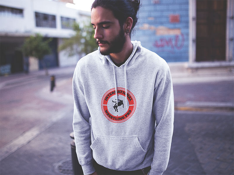 Hipster Man With Long Hair Wearing A Pullover Hoodie In A Downtown Street