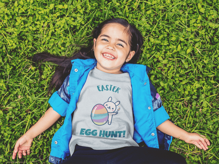 T Shirt Mockup Of A Little Girl Lying In The Grass Smiling A12099