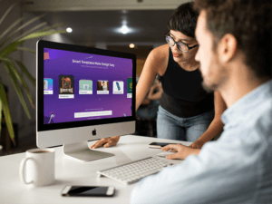 Girl Showing Something In Imac Mockup To Coworker A16266