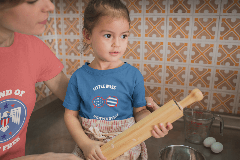 Girl Learning How To Cook Wearing A T Shirt Mockup With A Patriotic Design