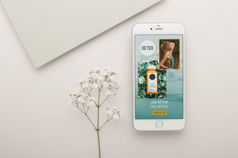 Silver Iphone Mockup Lying Next To Small White Flowers