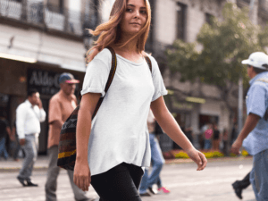 T Shirt Mockup Of A Hipster Woman Crossing The Street