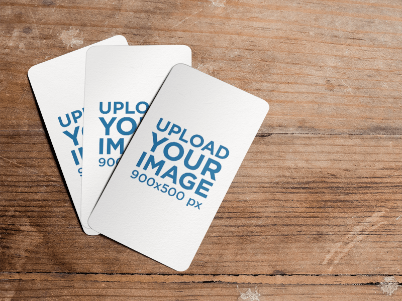 Mockup Featuring Three Business Cards Lying On Top Of A Wooden Table