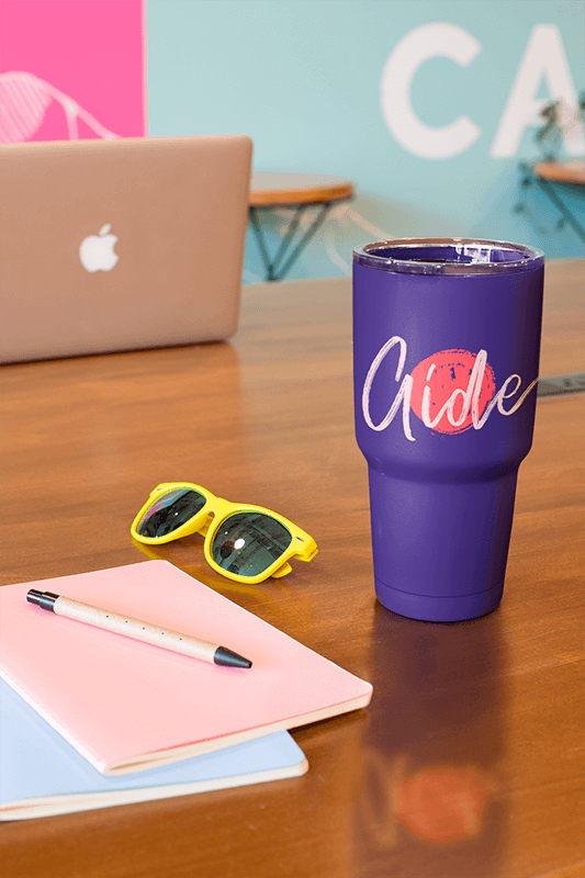 Mockup Of A Tumbler Standing On A Wooden Desk