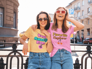 T Shirt And Crop Top Mockup Featuring Two Sisters Posing For Siblings Day