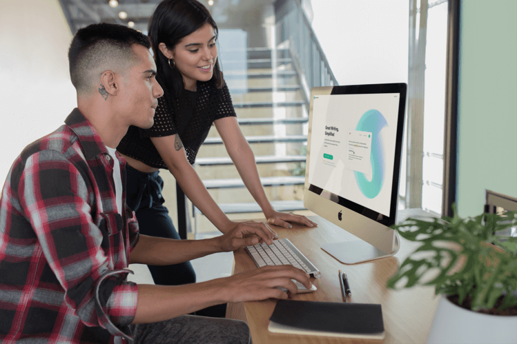 Couple Looking At Computer With Grammarly Open