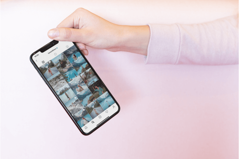 Mockup Of A Woman Holding An Iphone 11 Pro Featuring An Instagram Feed