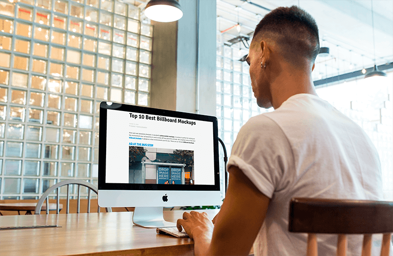 Imac Mockup Being Used By A Man At A Startup