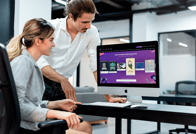 Man Coaching A Coworker Working On An Imac Mockup