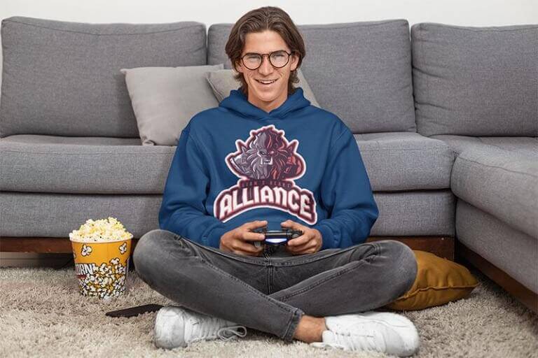 Pullover Hoodie Mockup Of A Man Playing Videogames At Home With A Popcorn Bucket