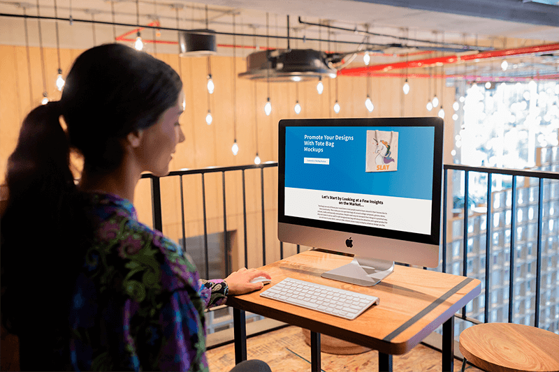 Woman Working With Imac Mockup At Her Workstation