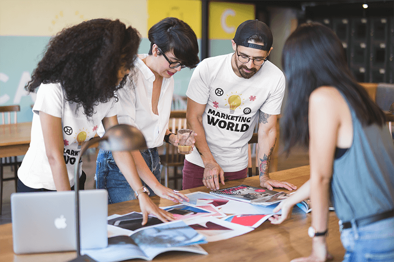 Team Of Coworkers Wearing Round Neck Tees Mockup While Brainstorming