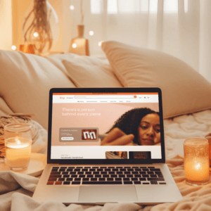 Macbook Pro Mockup Displaying Etsy Home Page Featuring A Cozy Setting With Candles And Flowers