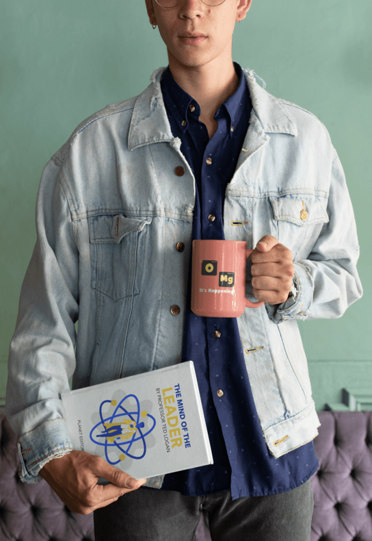 Mockup Of A Man Wearing A Denim Jacket And Holding A Coffee Mug And A Book 28465