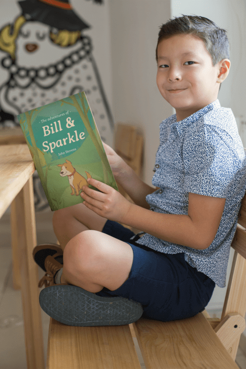 Book Mockup Of A Little Boy Reading And Smiling 23726