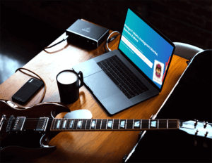 Macbook Pro Mockup Placed Next To A Guitar