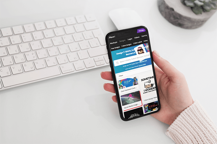 Mockup Featuring A Woman S Hand Holding An Iphone 11 Pro Over A Neat Desk